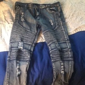 Tattered blue skinny biker jeans